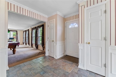 Foyer with view front door, two coat closets, and