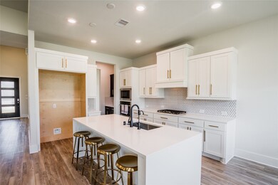 This kitchen is by far any chef’s dream! This spacious kitchen features white stained wood cabinets, quartz countertops, SS appliances, modern tile backsplash, recessed lighting, extended counter space, quartz kitchen island with space for breakfast bar, and a walk-in pantry all overlooking your huge family room.