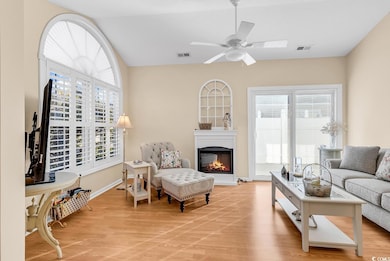 Living room featuring a ceiling fan, visible vents