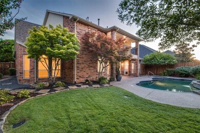 Professionally landscaped backyard with lush grass