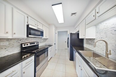 Spacious kitchen with ample storage, tile flooring, and a clean, modern design opening toward the main living areas.
