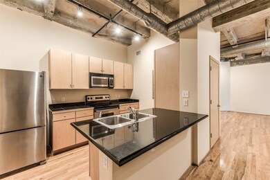 The kitchen features sleek stainless steel applian