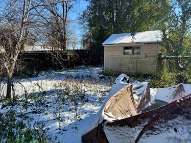 Yard covered in snow with a shed, an outdoor struc