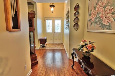 High ceiling in the foyer with glass chandelier an