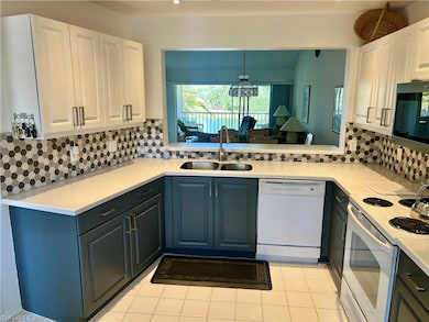 Kitchen featuring a sink, white appliances, and li