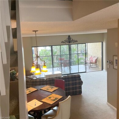 Dining and living area featuring carpet flooring