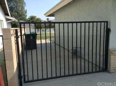 West side of house in front of gate from front to 
