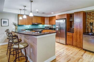 Kitchen has granite counter tops, breakfast bar, g