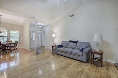 The Great Room features hardwood floors, a vaulted ceiling, a gas-log fireplace, and has plenty of room for furniture placement.