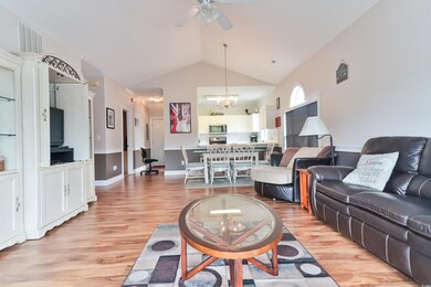 Living room with high vaulted ceiling, ceiling fan