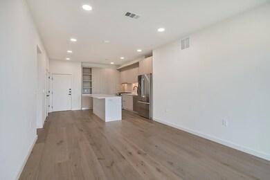 Unfurnished living room with baseboards, light wo