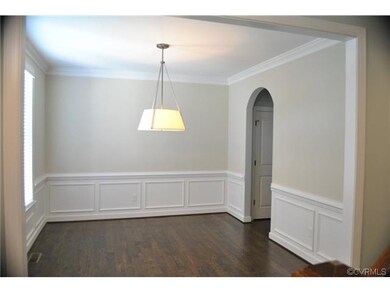 Formal Dining Room features Hardwood Floor, Crown & Chair Moldings, and 
