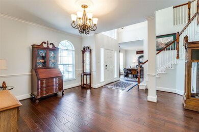 Foyer entrance featuring crown molding, decorative