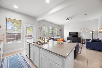 Kitchen with light tile patterned floors, white c