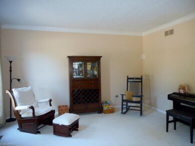 The formal living room is neutrally painted and cr