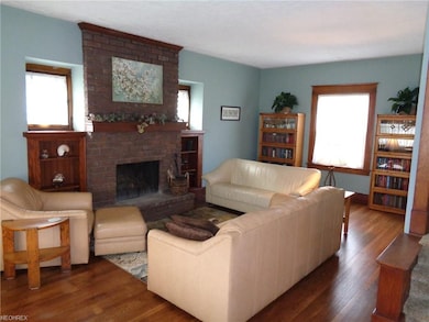 Living room with floor to ceiling wood burning fir
