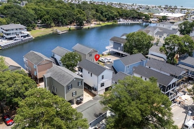 Aerial perspective of suburban area featuring a large body of water