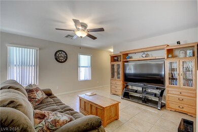 The spacious great room with ceiling fan.