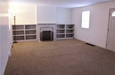 large living room with working fireplace and built