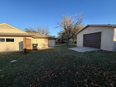 View of green lawn featuring an outdoor structure