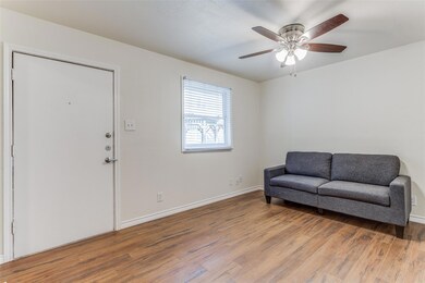 Living area featuring wood finished floors, a cei