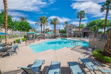 Community pool with a patio area and fence