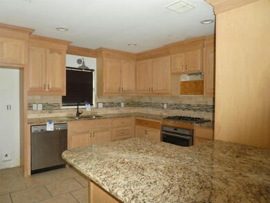 Kitchen with stainless steel appliances, light bro