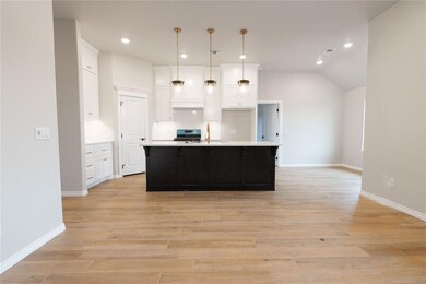 Kitchen featuring sink, decorative light fixtures,