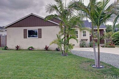 this home has an easy care lawn with lush palms li