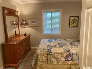 Bedroom with carpet and baseboards