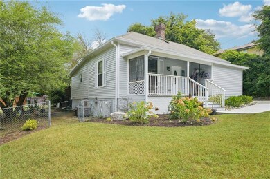 View of front of home with a porch and a chimney