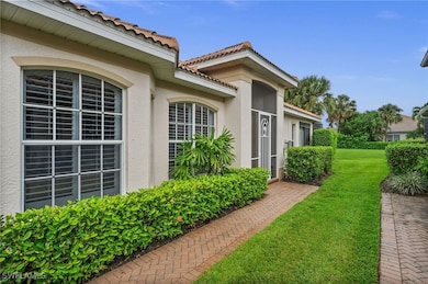 View of side of property with a lawn