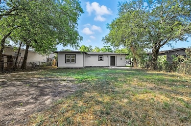 Rear view of property featuring a fenced backyard and a patio