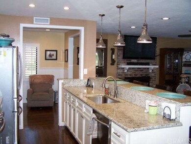 Kitchen with granite countertops; wood flooring, n