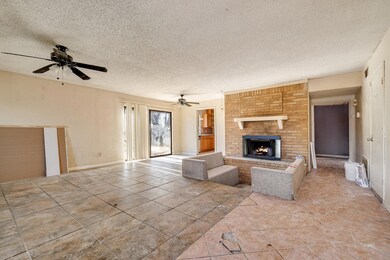 Unfurnished living room with ceiling fan, a textur