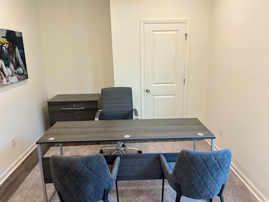 Office with baseboards and wood finished floors