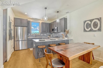 Kitchen featuring pendant lighting, light wood-typ
