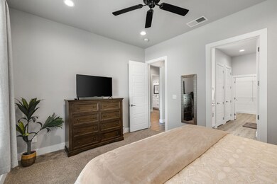 Bedroom with recessed lighting, ceiling fan, and light colored carpet