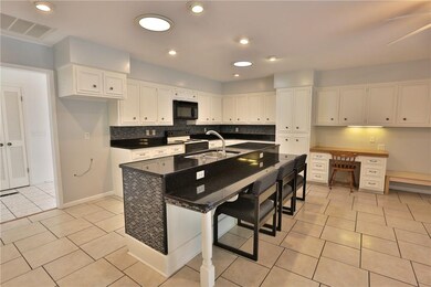 The low breakfast bar area and desk work space all