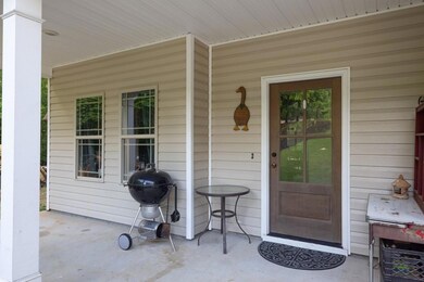 Doorway to property featuring covered porch