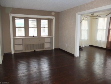Living room is open to the sun room with lake view