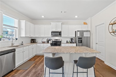 Kitchen featuring visible vents, a sink, a center 