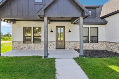 Doorway to property featuring a yard