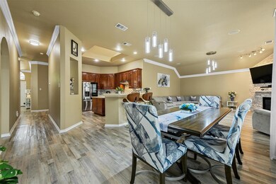 Dining space with ornamental molding, light hardwo