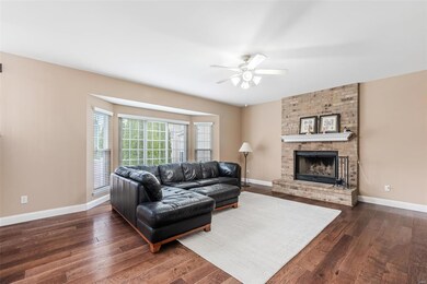 Great room w/ bay window and brick wood burning fi