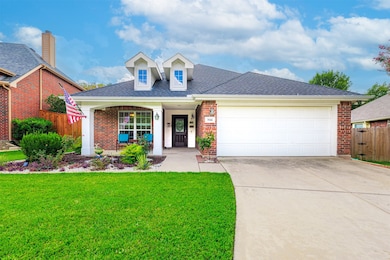 View of front facade with covered porch, brick siding, a shingled roof, concrete driveway, and a garage