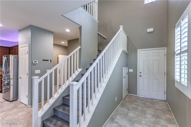 Staircase featuring plenty of natural light and a high ceiling