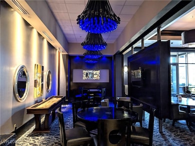 Recreation room featuring a paneled ceiling and a chandelier