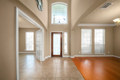 Welcome to a grand entryway featuring elegant hard