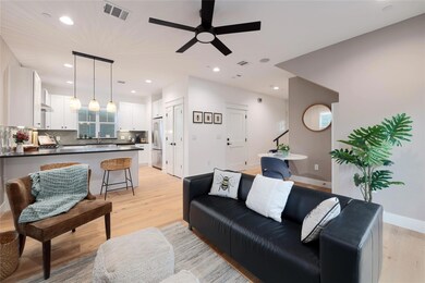 Living area with recessed lighting, visible vents